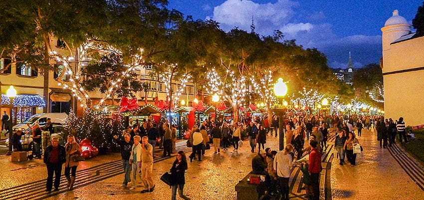 Mercadillo Navideño en Funchal, Madeira, con actuaciones musicales y productos locales como vino de Madeira y pan de miel.