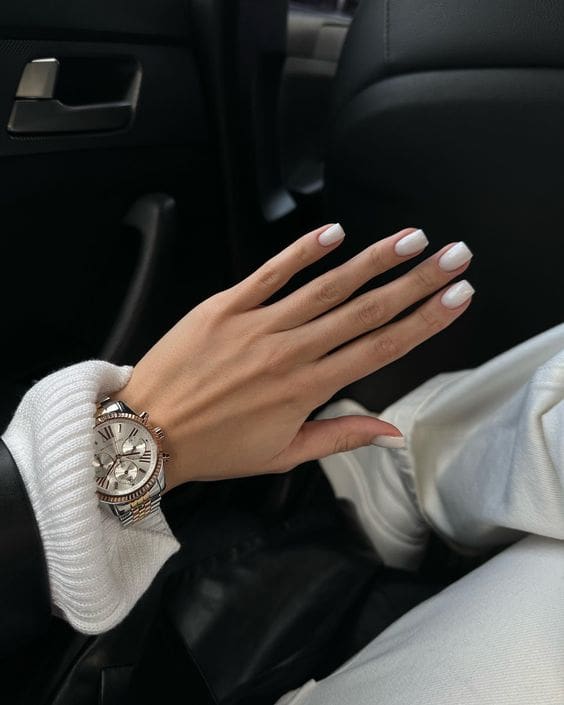 Primer plano de uñas para novia, con acabado blanco lechoso y brillante.